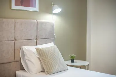 a bed with a headboard and a pillow on it at The 