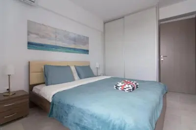 a bedroom with a large bed with a blue blanket at New spacious apartment located in Piraeus in Piraeus