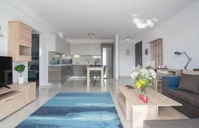 a living room and kitchen with a couch and a table at New spacious apartment located in Piraeus in Piraeus