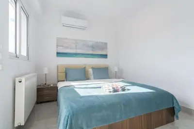 a bedroom with a large bed with a blue blanket at New spacious apartment located in Piraeus in Piraeus