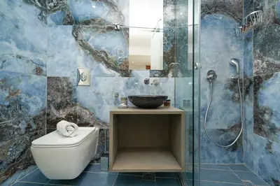 a bathroom with a toilet and a glass shower at Stylish Living-Parthenon in Athens