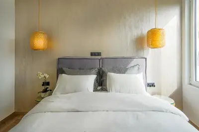 a bed with two white pillows and two lights at Stylish Living-Parthenon in Athens