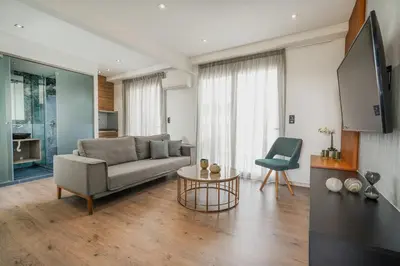 a living room with a couch and a table at Stylish Living-Parthenon in Athens