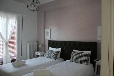 a bedroom with two beds and a window at Suite 2 Bedrooms in Athens