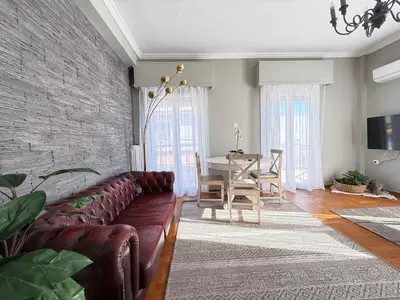 a living room with a couch and a table at Suite 2 Bedrooms in Athens