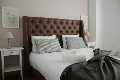 a bedroom with a large bed with white sheets and pillows at Suite 2 Bedrooms in Athens
