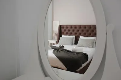 a mirror reflection of a bed in a bedroom at Suite 2 Bedrooms in Athens