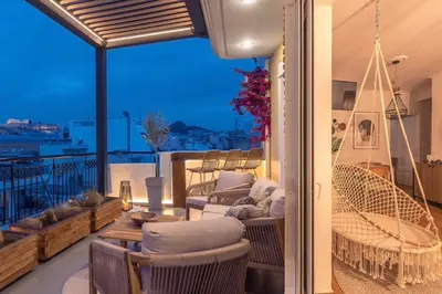 a balcony with chairs and a table on a balcony at Parthenon Dream, breathtaking views with massage chair in Athens