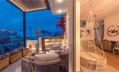 a living room with a hammock on a balcony at Parthenon Dream, breathtaking views with massage chair in Athens