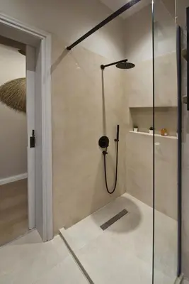 a shower with a glass door in a bathroom at Stylish Apartment at Pagrati in Athens