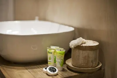 a bathroom with a tub and a sink and toiletries at Stylish Apartment at Pagrati in Athens