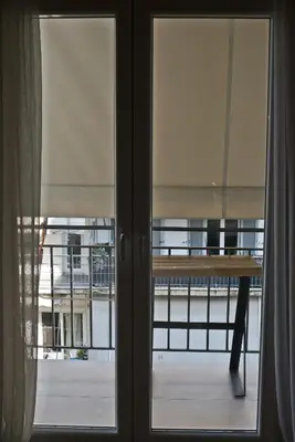 a window with a table and a view of a building at Stylish Apartment at Pagrati in Athens
