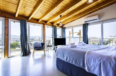 a bedroom with a bed and large windows at Lis153 by Smart Cozy Suites - Top Floors with Amazing City View - Available 24hr in Athens