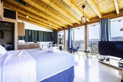 a large bedroom with a large bed and a kitchen at Lis153 by Smart Cozy Suites - Top Floors with Amazing City View - Available 24hr in Athens