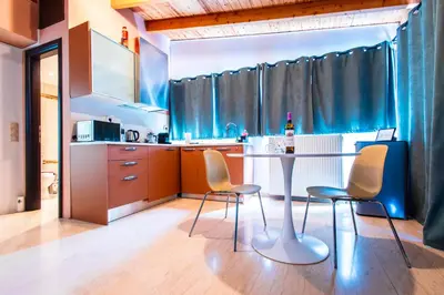 a kitchen with a table and chairs in a room at Lis153 by Smart Cozy Suites - Top Floors with Amazing City View - Available 24hr in Athens