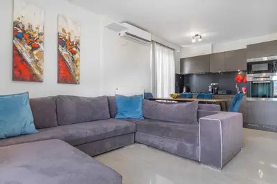 a living room with a couch and a kitchen at Lis153 by Smart Cozy Suites - Top Floors with Amazing City View - Available 24hr in Athens
