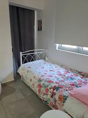 a bedroom with a bed with a floral bedspread at Landscape luxury flat Psyrri square in Athens