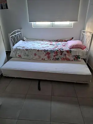 a bedroom with a bed with a floweridered blanket at Landscape luxury flat Psyrri square in Athens