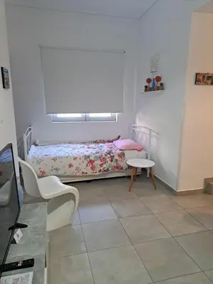 a small bedroom with a bed and a table at Landscape luxury flat Psyrri square in Athens