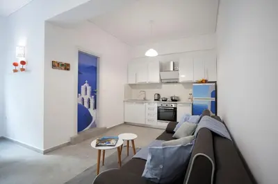 a living room with a couch and a kitchen at Landscape luxury flat Psyrri square in Athens