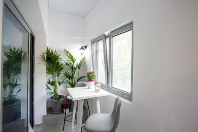a white table and chairs in a room with plants at Landscape luxury flat Psyrri square in Athens