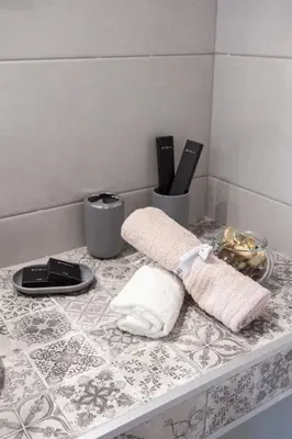 a bathroom counter with towels and utensils on it at Fedias Luxury flat Psyrri square in Athens