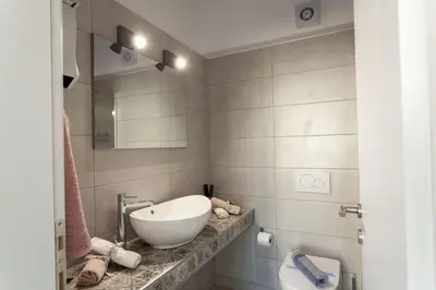 a bathroom with a sink and a bowl on a counter at Fedias Luxury flat Psyrri square in Athens