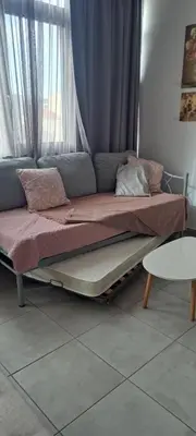 a bed sitting in a room with a window at Fedias Luxury flat Psyrri square in Athens
