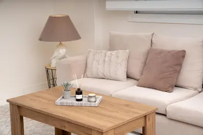 a living room with a couch and a coffee table at Ozone Complex by A&D Properties in Porto Rafti