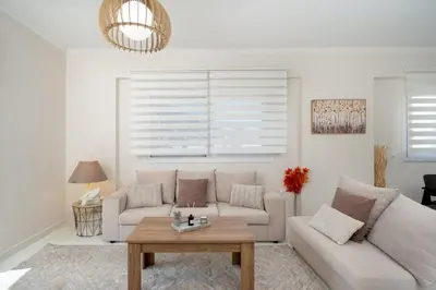 a living room with a couch and a table at Ozone Complex by A&D Properties in Porto Rafti