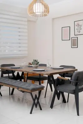 a dining room with a wooden table and chairs at Ozone Complex by A&D Properties in Porto Rafti