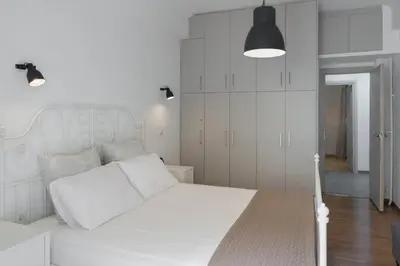 a white bedroom with a white bed and white cabinets at Amazing apartment 2 min to Acropolis in Athens