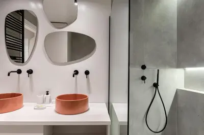 a bathroom with two sinks and a mirror at Acropolis White Key Residence in Athens