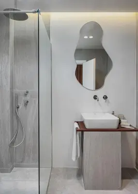 a bathroom with a sink and a mirror at Acropolis White Key Residence in Athens