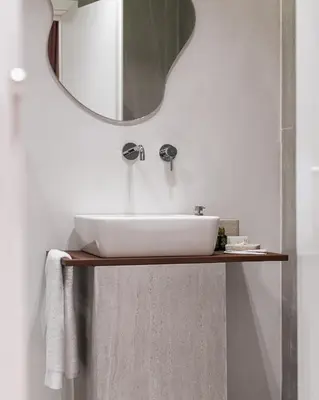 a bathroom with a white sink and a mirror at Acropolis White Key Residence in Athens