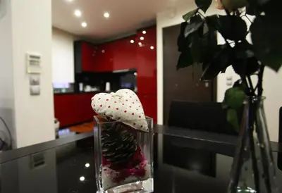 a glass vase with a plant in a room at Olvias Apartment in Athens