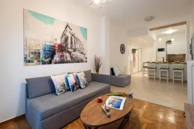 a living room with a couch and a table at Blue Ark Comfort near Acropolis in Athens