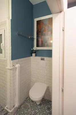a bathroom with a toilet and a blue wall at Blue Ark Comfort near Acropolis in Athens