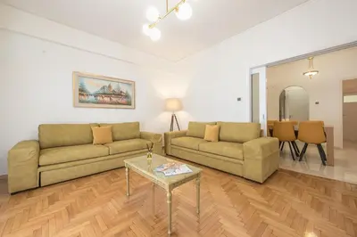 a living room with two couches and a table at Victoria Majestic Suites Apartments in Athens
