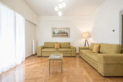 a living room with two couches and a table at Victoria Majestic Suites Apartments in Athens