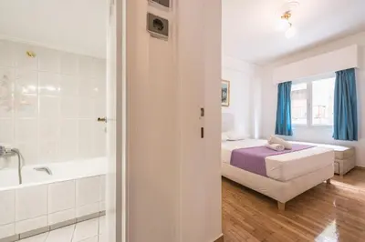 a bedroom with a bed and a bath tub at Victoria Majestic Suites Apartments in Athens