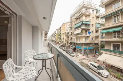 a balcony with a table and chairs and a view of a city at Victoria Majestic Suites Apartments in Athens