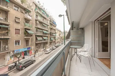 a balcony with a table and a view of a street at Victoria Majestic Suites Apartments in Athens