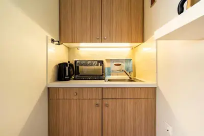 a small kitchen with a sink and a microwave at Agia Paraskevi luxury loft in Athens