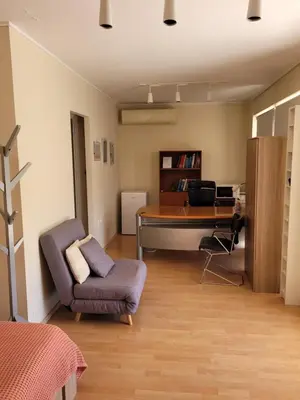 a bedroom with a desk and a chair and a couch at Agia Paraskevi luxury loft in Athens