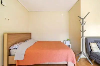 a bedroom with a bed with a orange blanket at Agia Paraskevi luxury loft in Athens