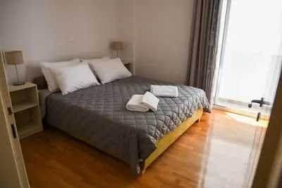 a bedroom with a bed with two towels on it at Ageliki's Athens Apartment in Athens