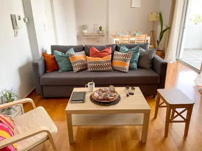 a living room with a couch and a coffee table at Ageliki's Athens Apartment in Athens