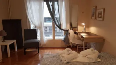 a room with a desk and a table with towels on the floor at Begonia-Athens Center, 6 BD, 2,5 BATH in Athens