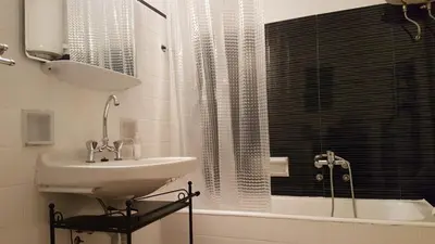 a bathroom with a sink and a shower and a tub at Begonia-Athens Center, 6 BD, 2,5 BATH in Athens